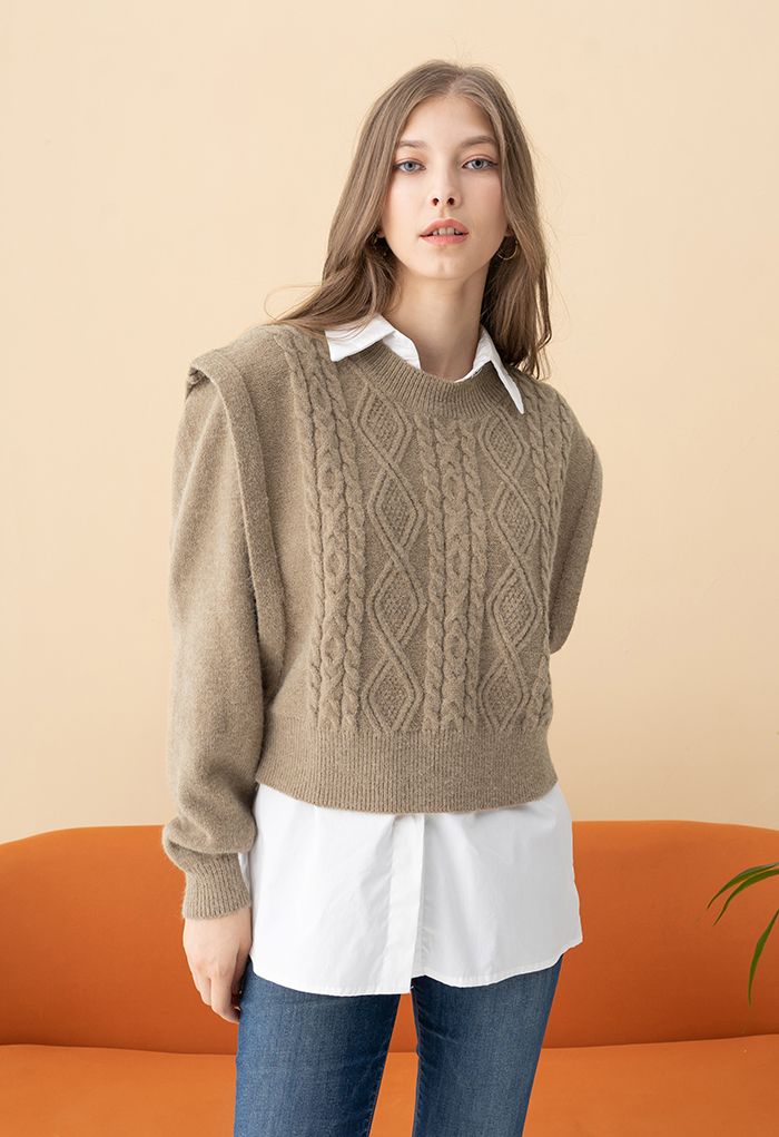 model wearing a tan sweater over a white button down top