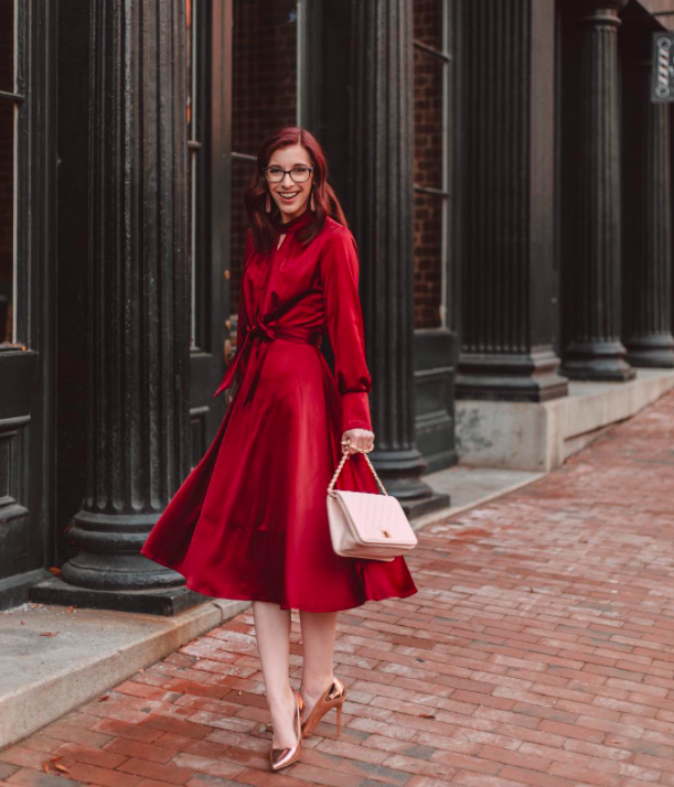 blogger wearing the satin red holiday dress