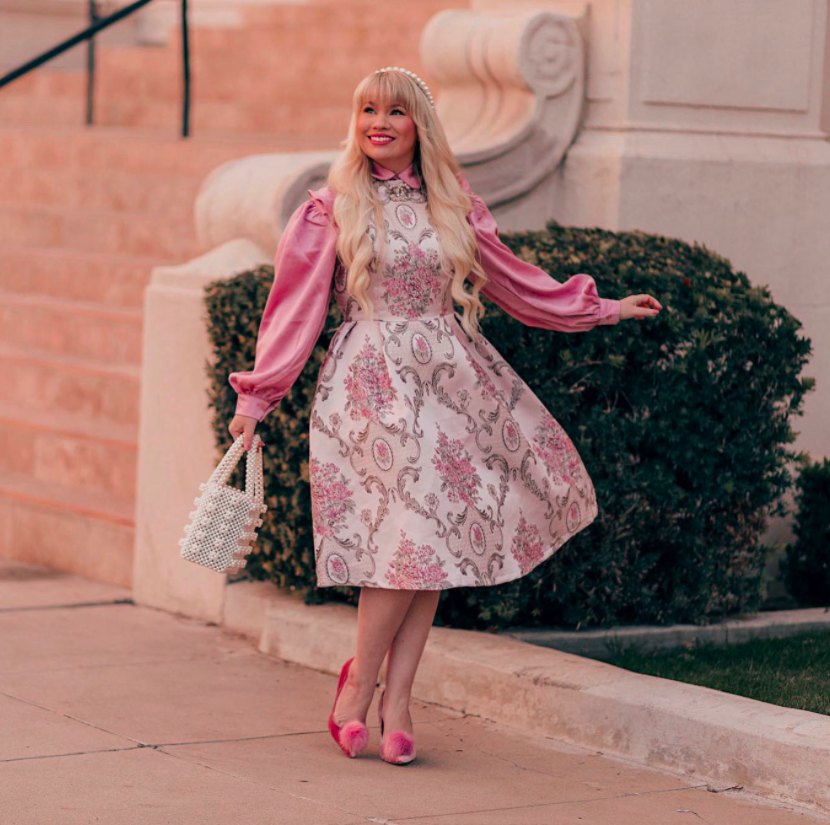 vlogger lizzie in lace wearing the pink floral jacquard dress with a hot pink long-sleeved blosue
