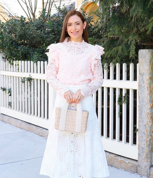 blogger wearing light pink floral lace blouse with long sleeves and ruffles on the shoulders