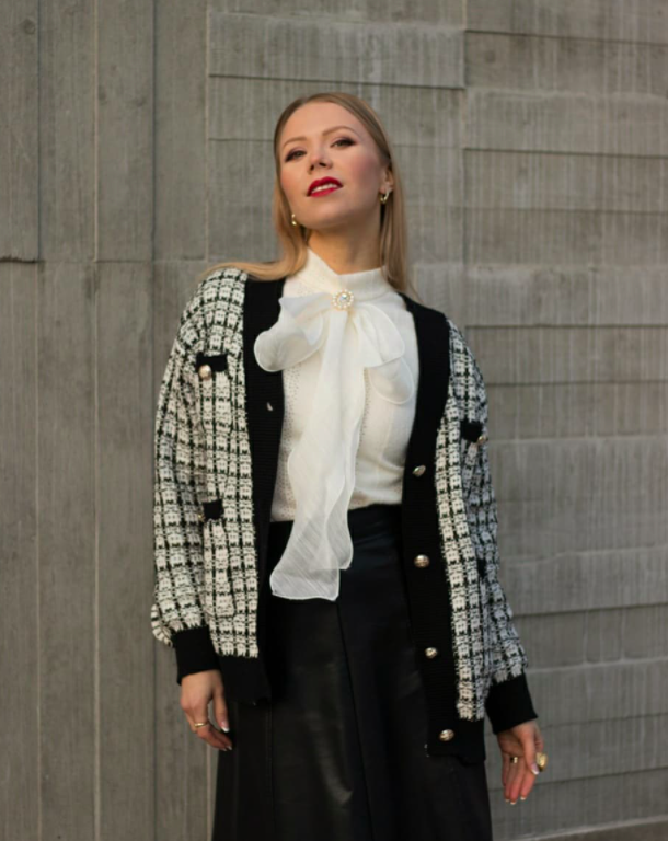blogger wearing whtie and black tweed-looking cardigan that's actually made of knit