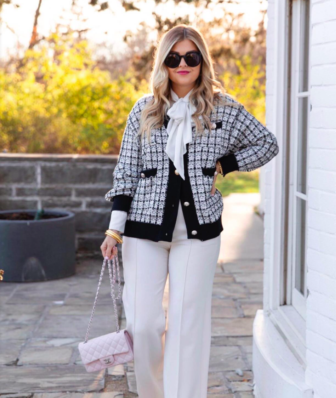 blogger wearing cardigan with dress pants and a pink Chanel bag